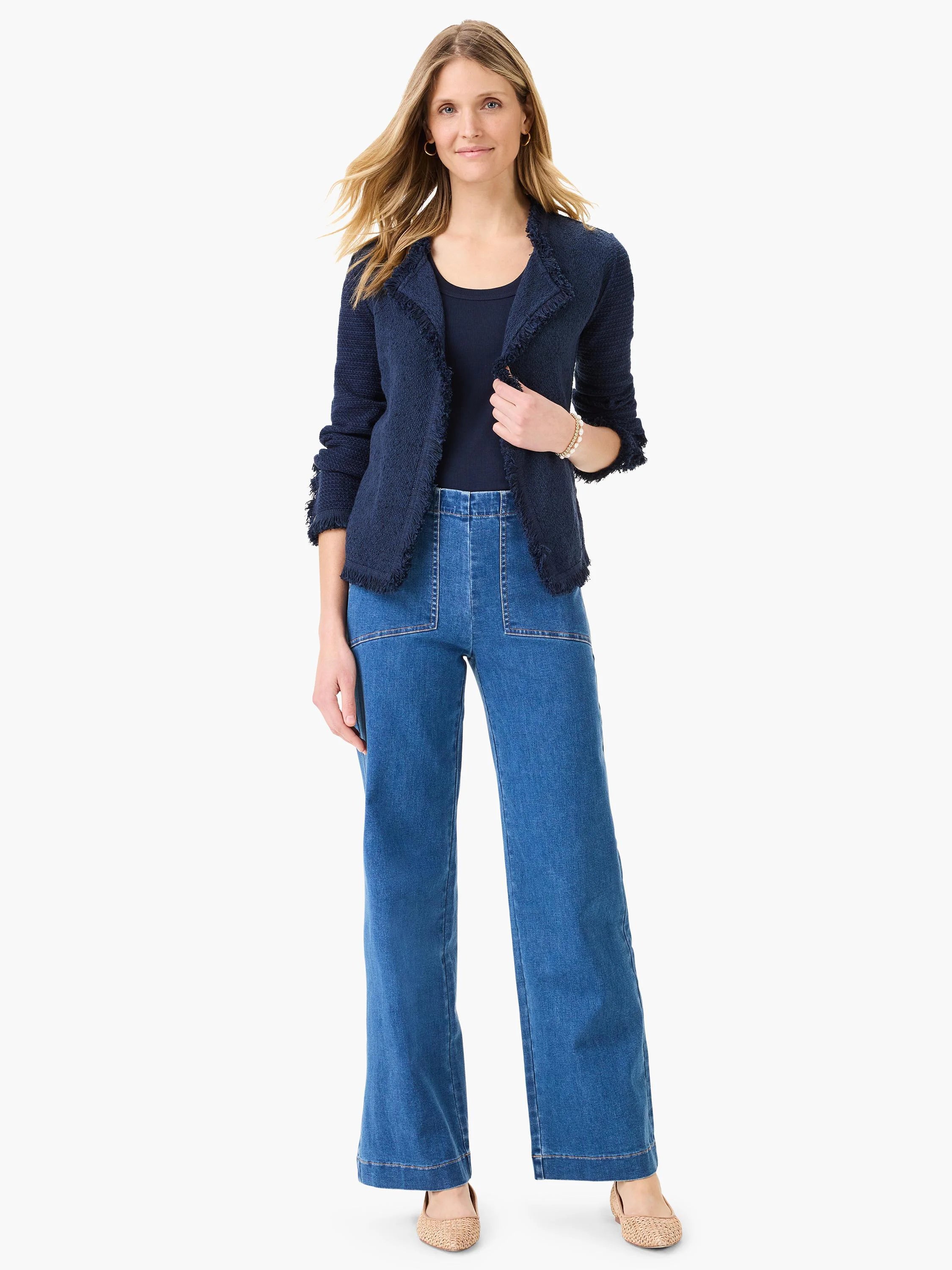 Medium blue wide-leg jeans with prominent front patch pockets and visible topstitching.