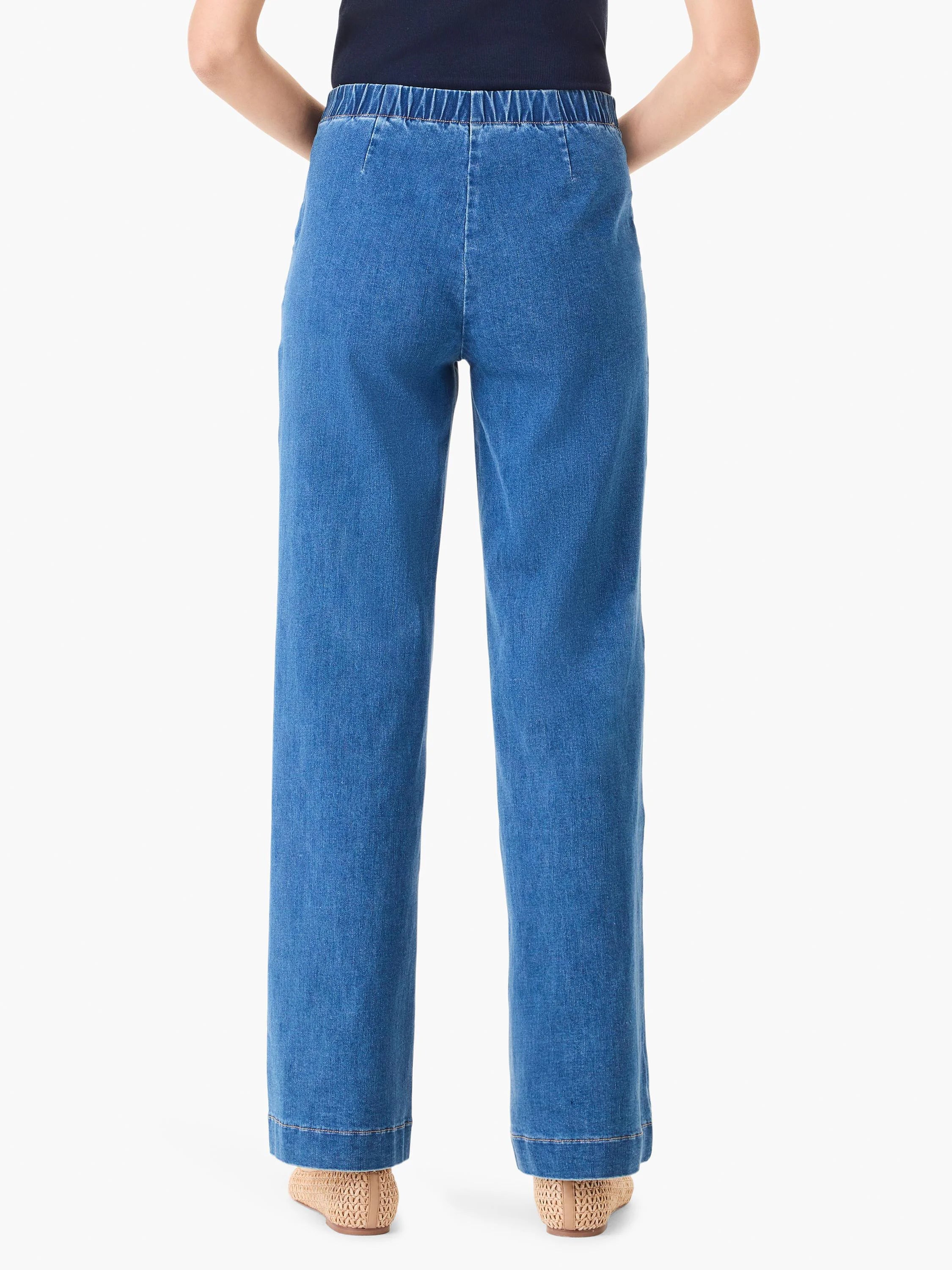 Back view of medium blue wide leg jeans with a gathered elastic waistband.