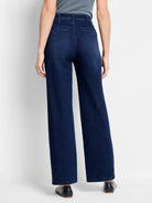 Dark wash, wide-leg jeans; back view.  High-waisted with visible back pockets.