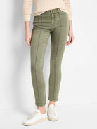 Olive green carpenter jeans with vertical seams down the front, fitted on model.