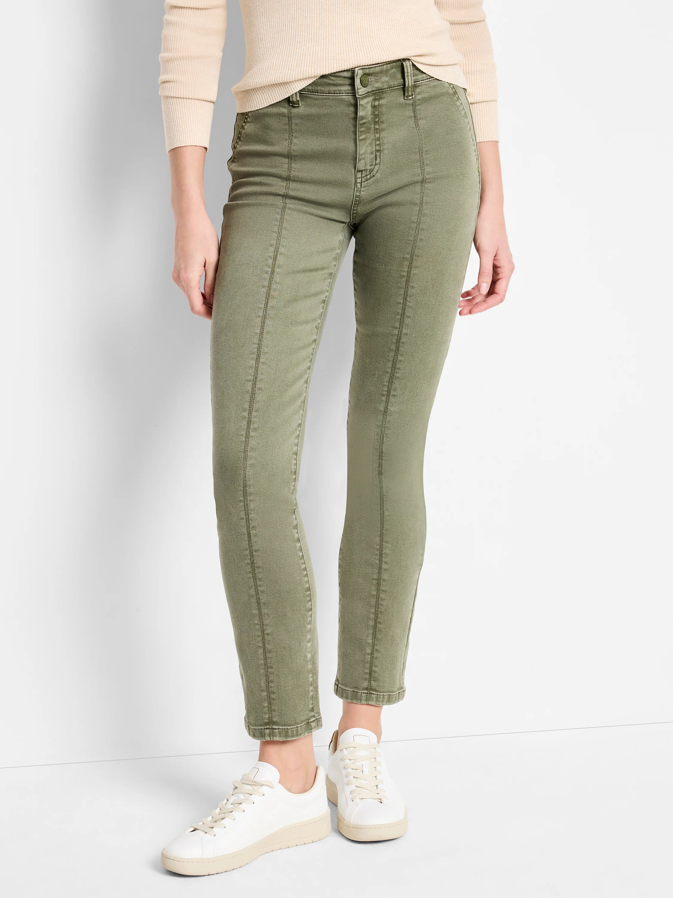 Olive green carpenter jeans with vertical seams down the front, fitted on model.