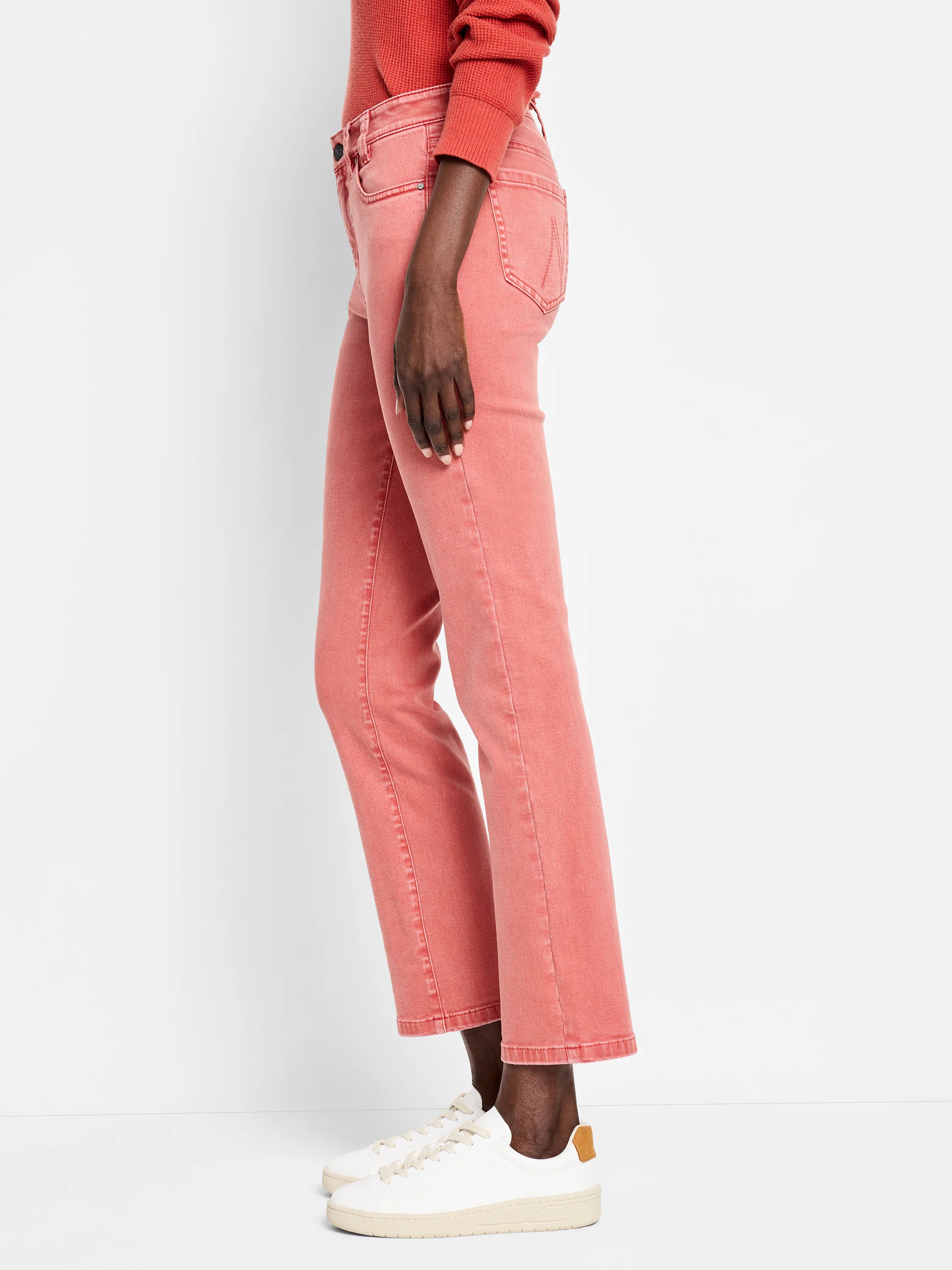 Faded coral straight ankle jeans on a model.