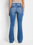Medium blue bootcut jeans, back view. Flap back pockets with buttons, visible side panel stitching, and flared leg opening.