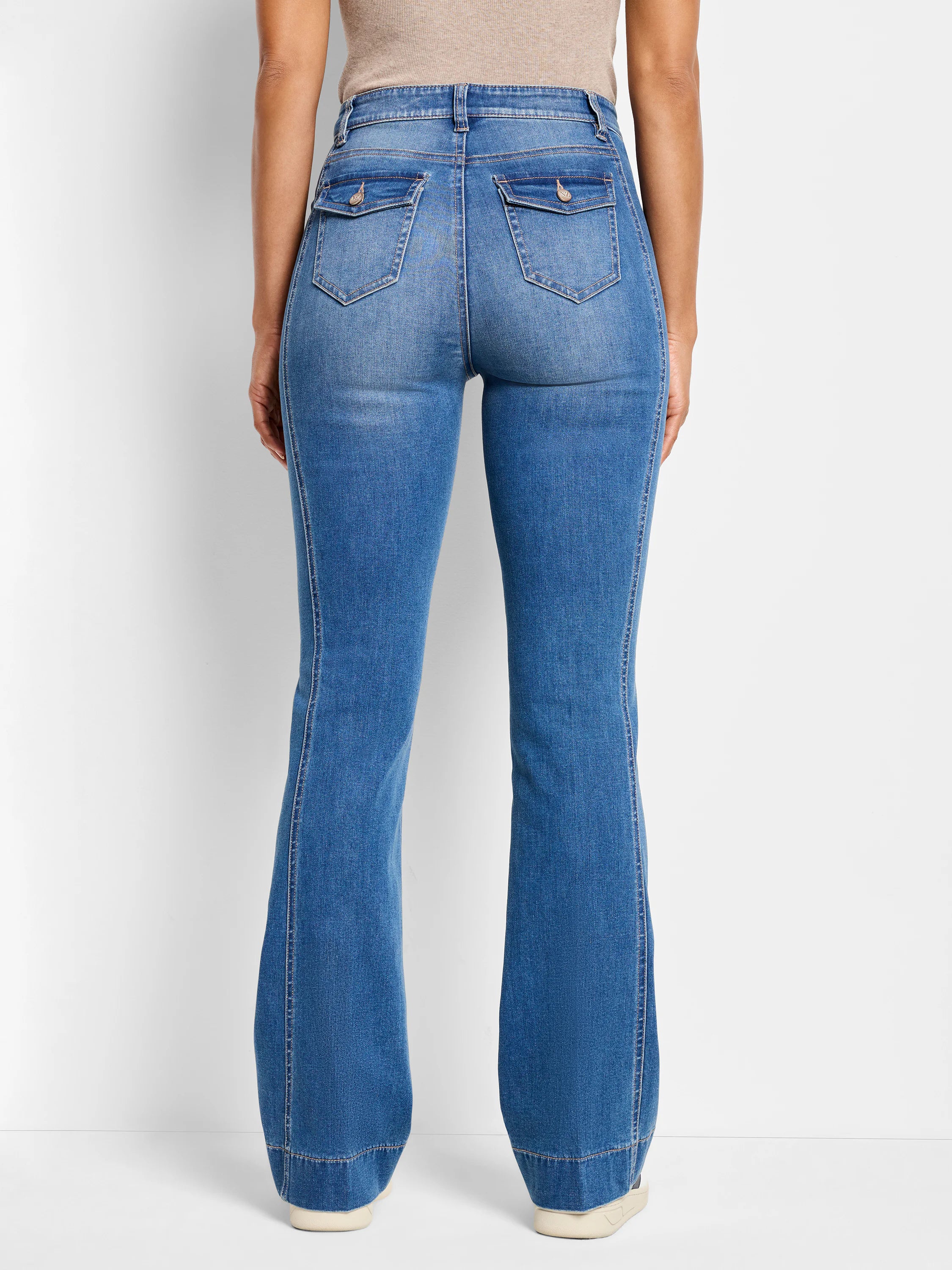 Medium blue bootcut jeans, back view. Flap back pockets with buttons, visible side panel stitching, and flared leg opening.