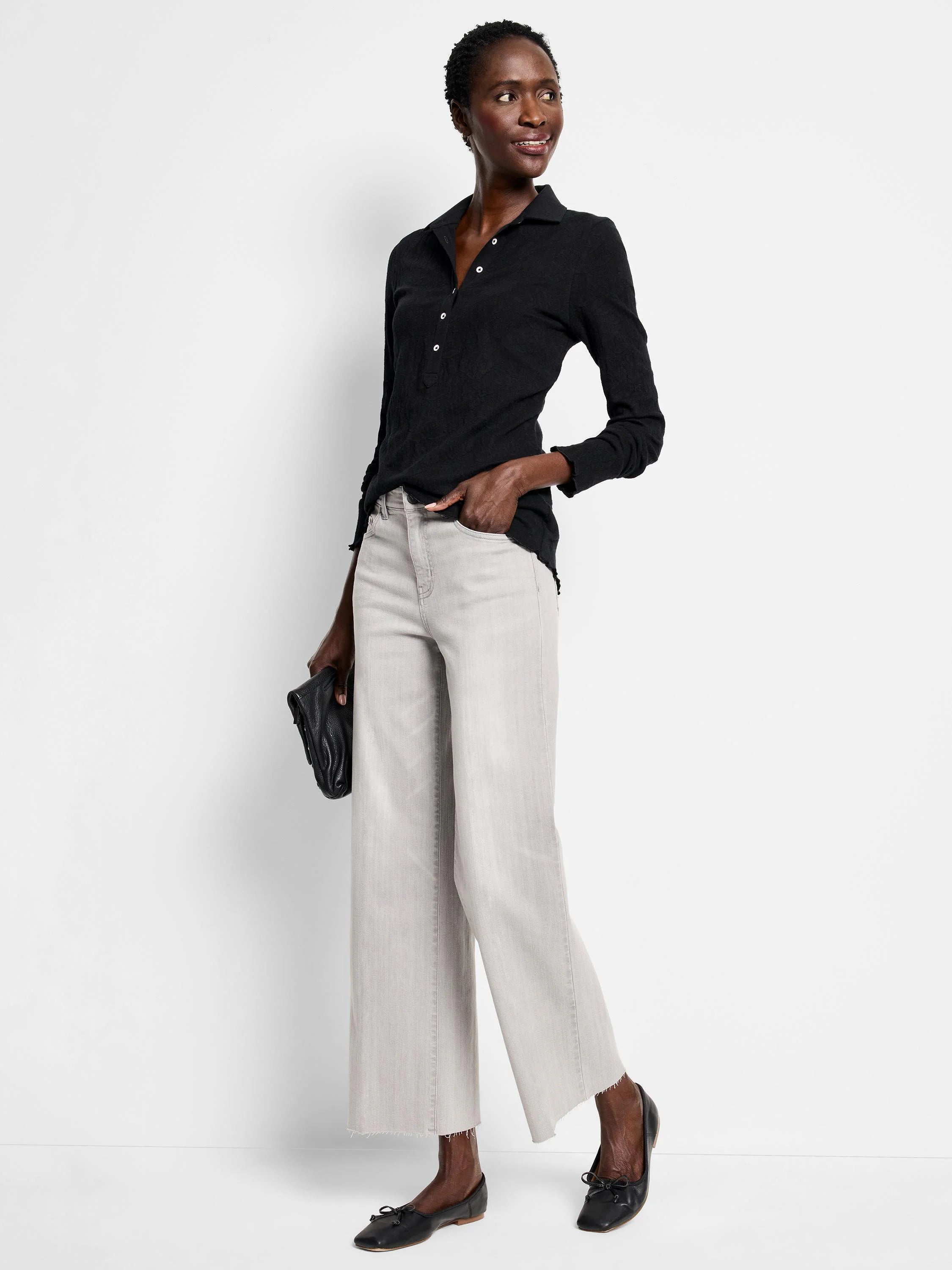 Faded light gray wide leg jeans with a cropped, frayed hem.