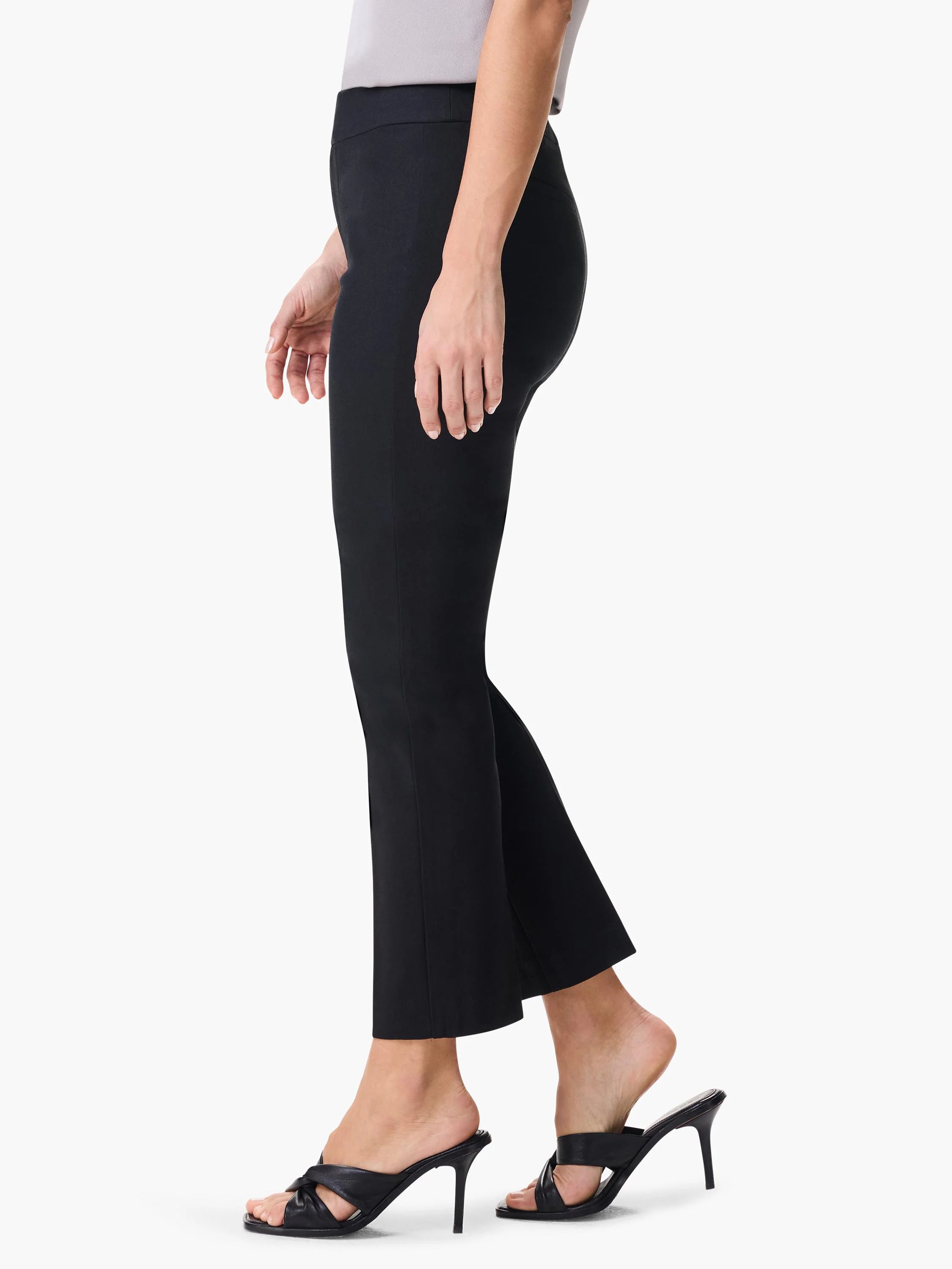 Black straight-leg pants shown on a model from the side.  The pants are cropped at the ankle.