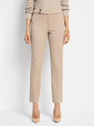Beige straight-leg pants with a hidden button closure.  The pants are shown on a model.