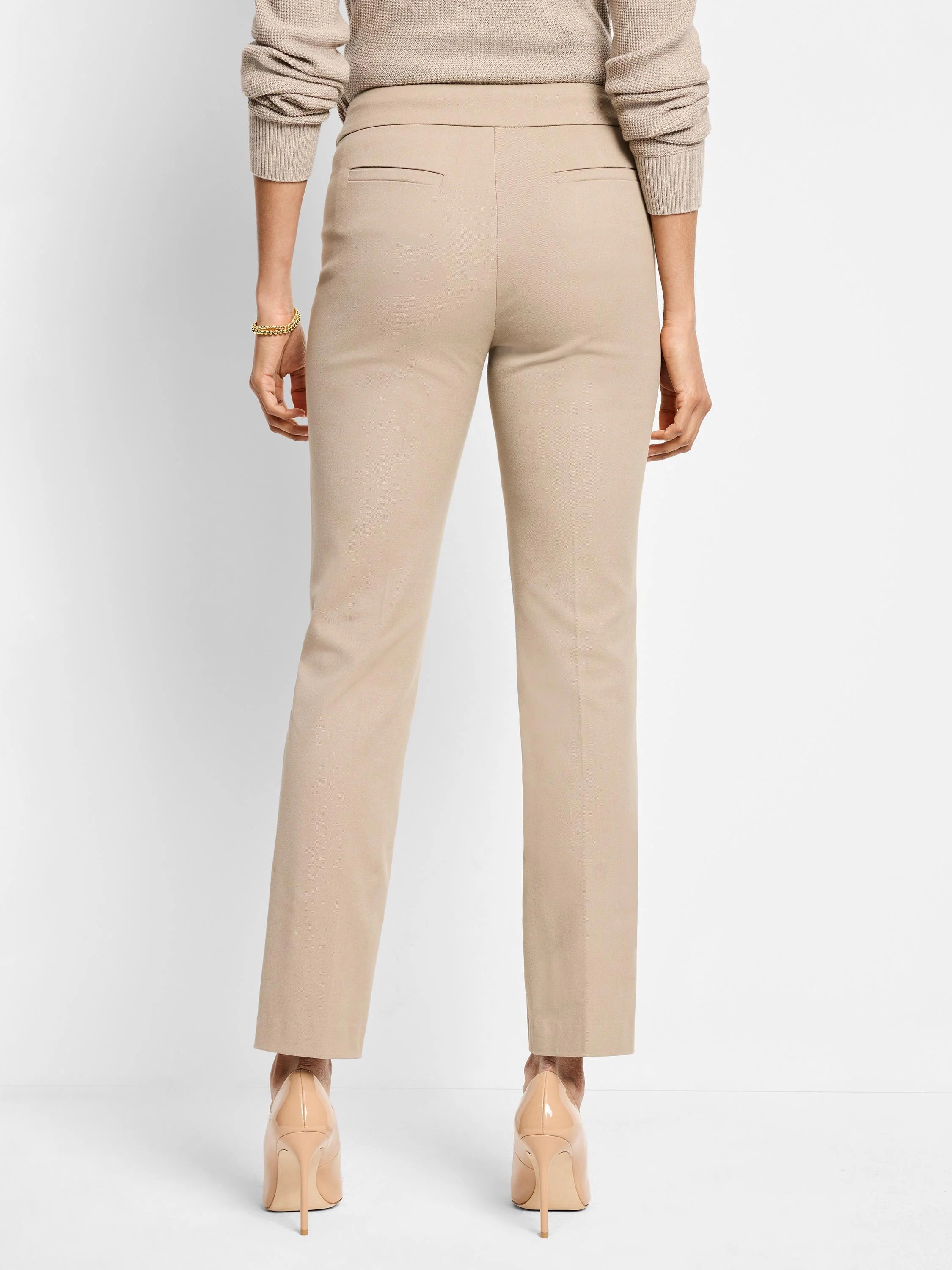 Beige straight-leg pants; back view.  Mid-rise waist.  Solid color.