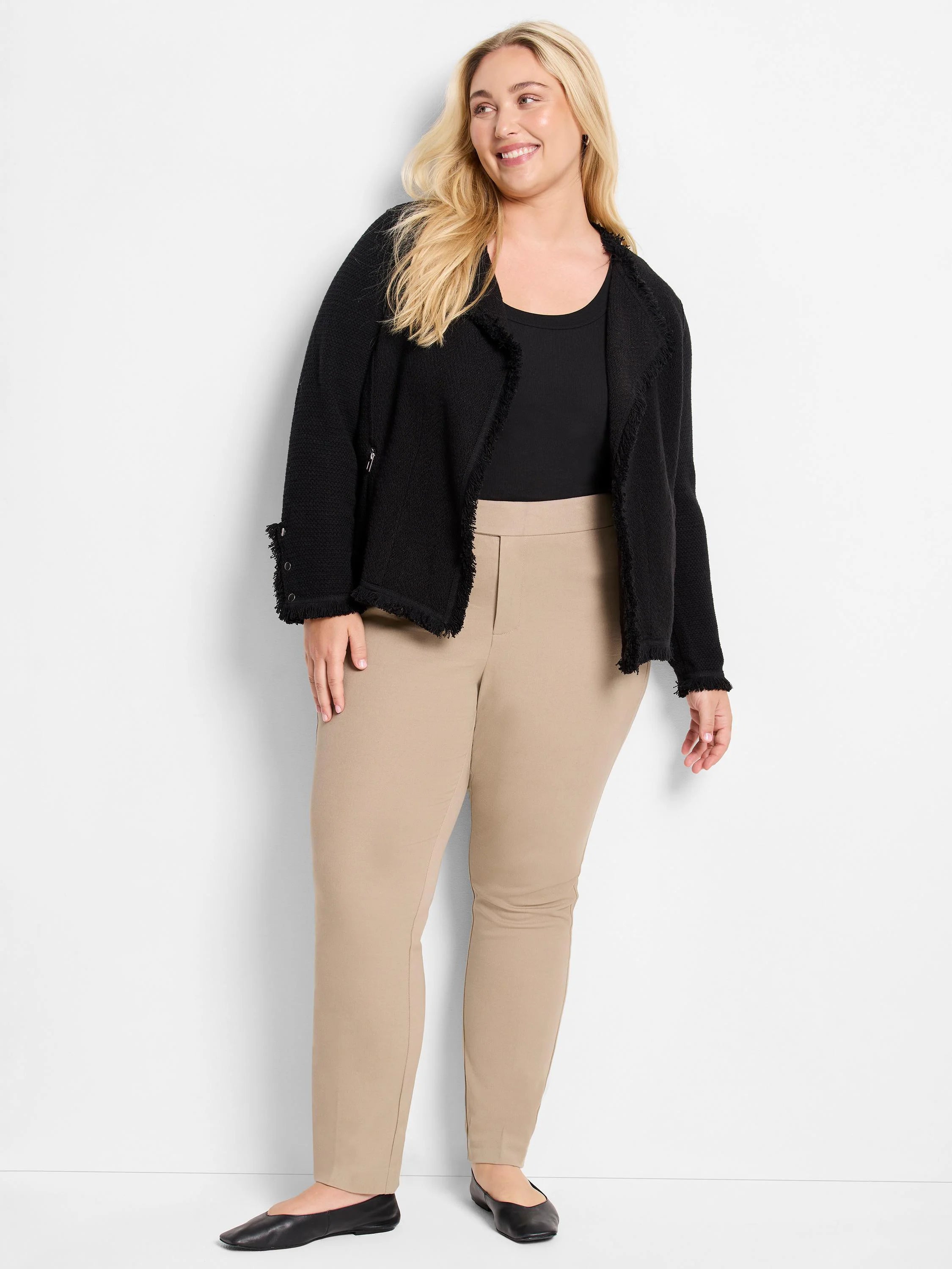 Beige straight-leg pants on a model.  The pants are a light beige.  A black jacket is also visible.