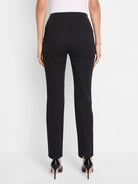 Black slim-leg pants, center back view.  Vertical seams visible.  Slight slits at the hem.