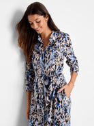 Long-sleeved shirt dress with belted waist.  Blue, brown, and beige chevron print.  Features front pockets.
