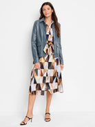 Teal shirt dress with geometric print in browns, beige, and black.  A teal jacket is shown layered over it.