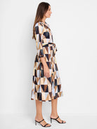 Midi shirt dress with belted waist. Geometric pattern in beige, brown, dark-blue and black triangles.  Three-quarter sleeves.
