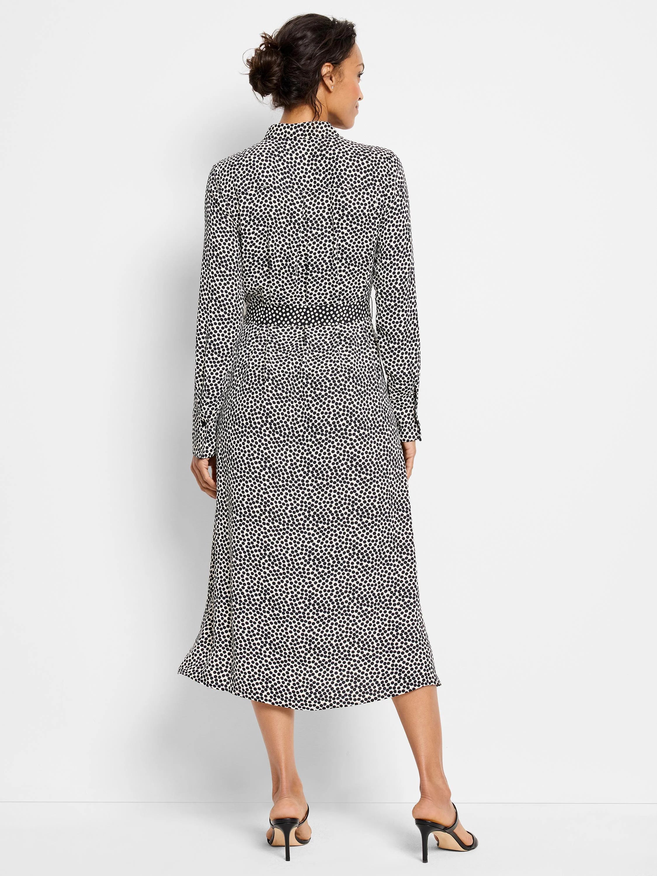 Off-white midi dress with dark-navy spots, long sleeves, collared neckline, and a belted waist.