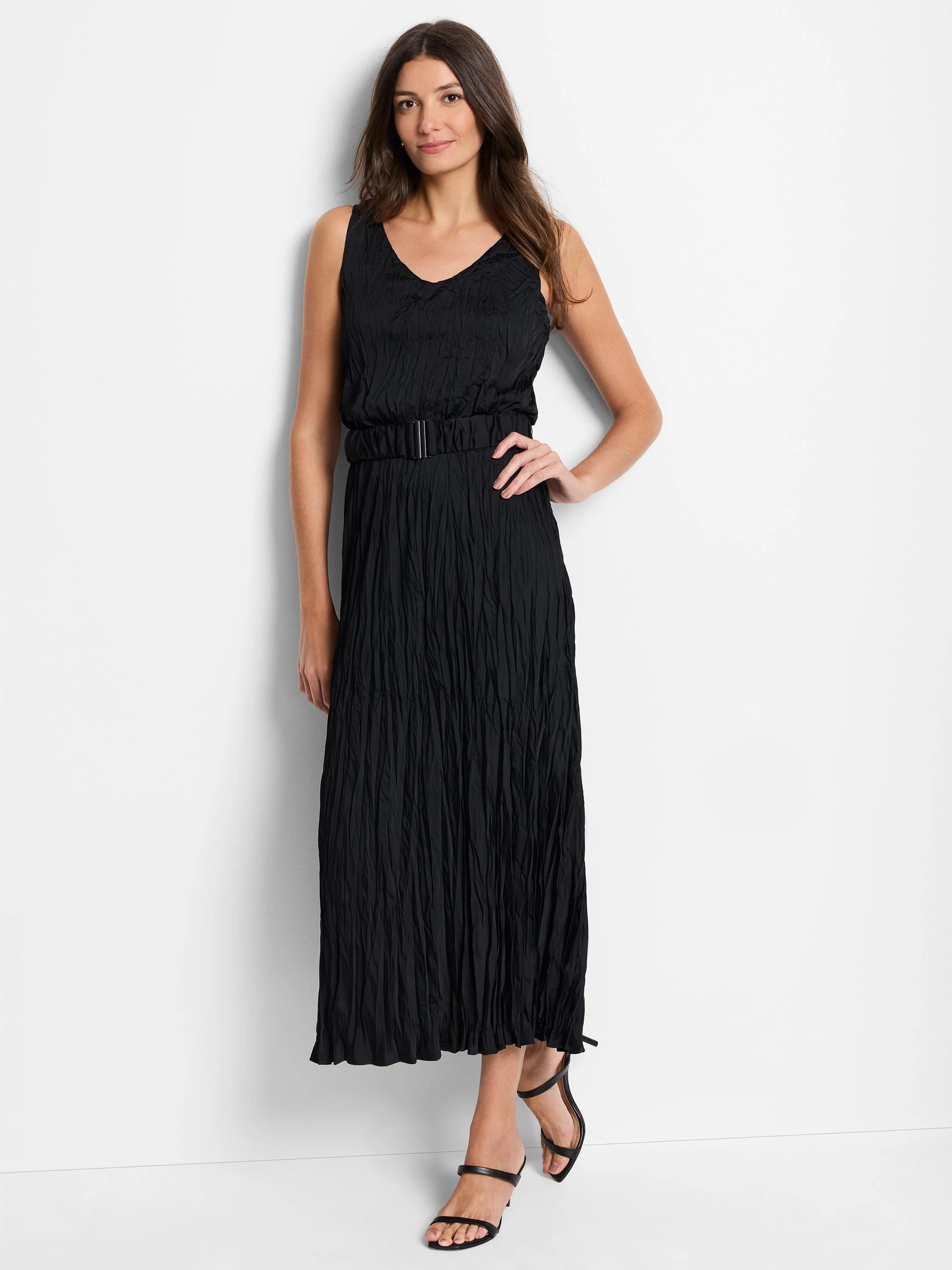 Black sleeveless maxi dress with a V-neck, belted waist, and textured, pleated fabric.