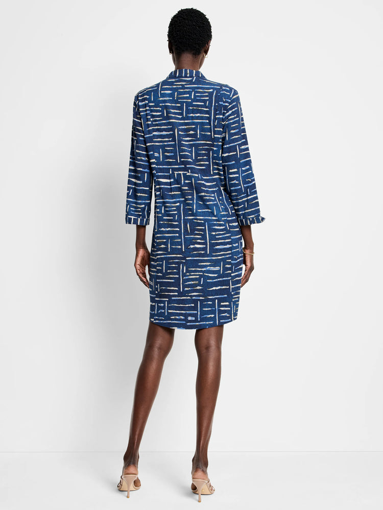 Indigo dress, knee-length, with a geometric pattern in lighter blues and beige on a dark indigo background. ...