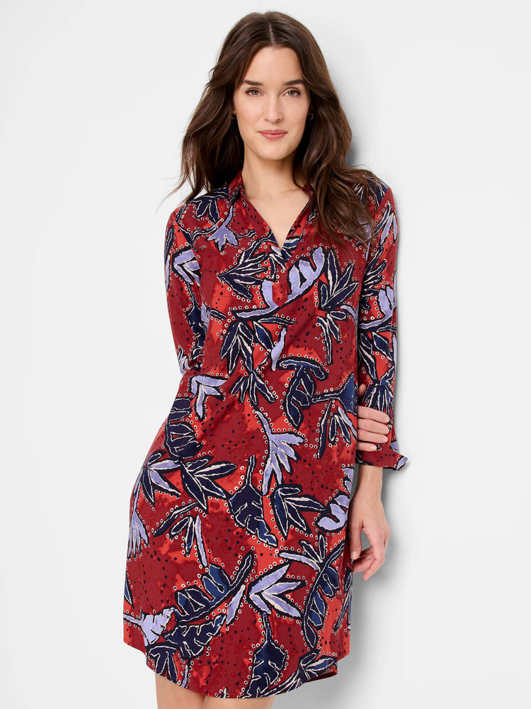 Rust shirt dress with long sleeves and an abstract pattern of navy, lavender, and white outlined leaves.