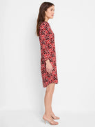 Red, maroon, and off-white geometric print knee-length dress; three-quarter sleeves.