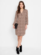 Brown mini dress with a black geometric pattern, V-neck, and three-quarter sleeves.