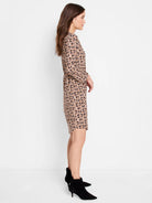 Beige midi dress with a dark brown/black geometric print.  Three-quarter sleeves.
