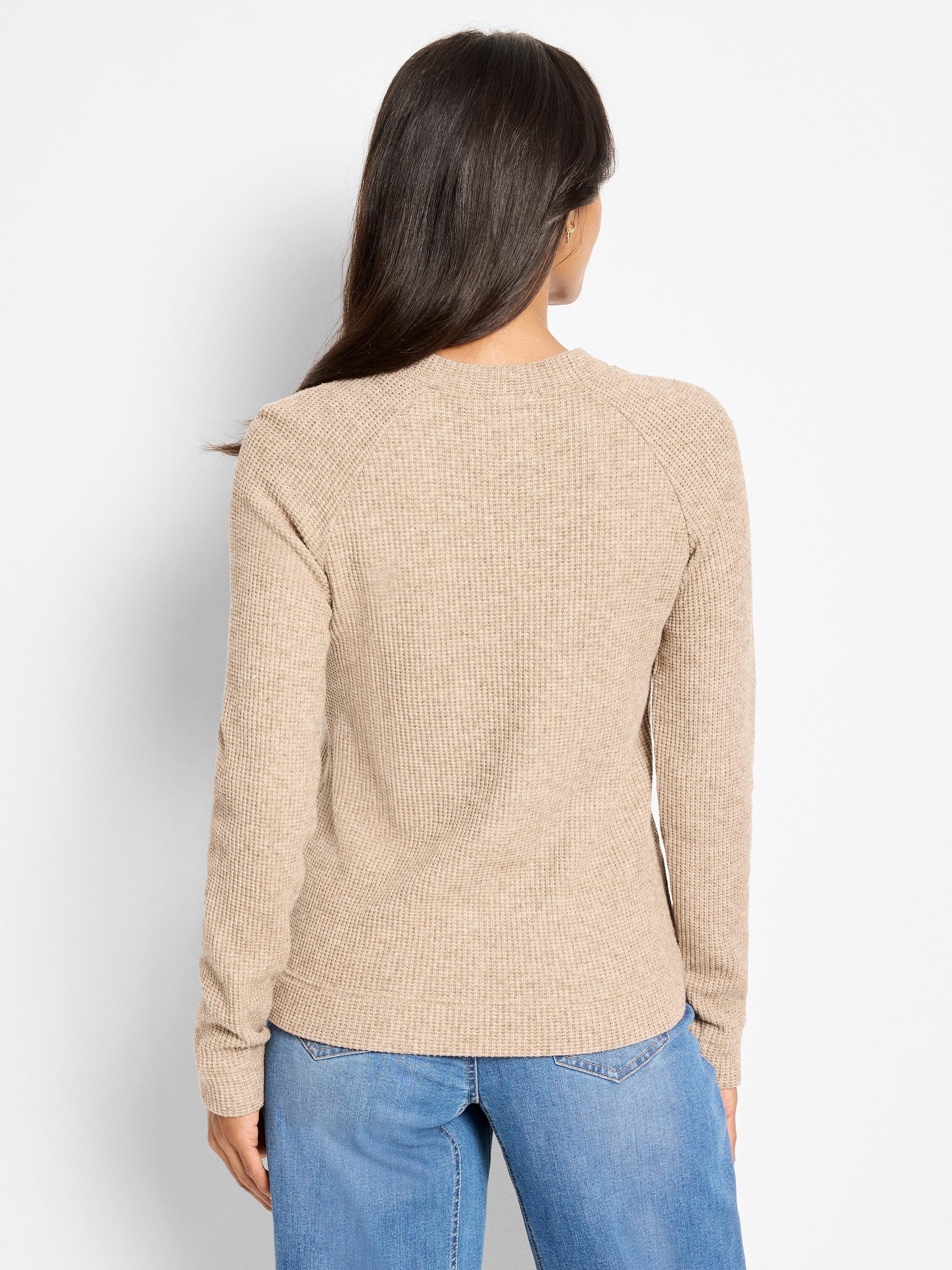 Back view of a light beige thermal top. Features waffle knit texture, long raglan sleeves, and a crew neck.