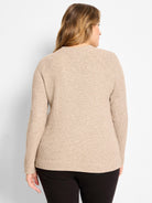 Oatmeal thermal waffle knit long-sleeved top, ribbed cuffs and hem. Model shown from back.