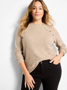 Beige thermal knit long-sleeve top with gold buttons arranged diagonally on the left shoulder.