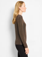 Fitted, long-sleeve top in shimmering bronze-brown knit. Model shown in profile.