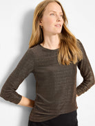 Black long-sleeved top with a round neck and metallic gold speckled knit texture.