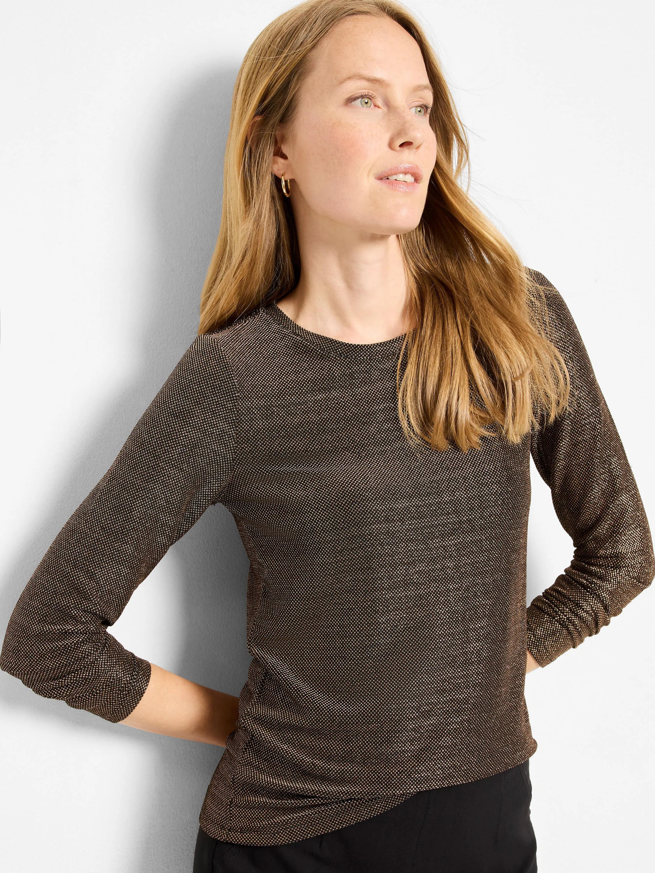 Black long-sleeved top with a round neck and metallic gold speckled knit texture.