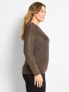 Long-sleeved knit top, dark bronze with dense, shimmering gold flecks. Worn by a woman in profile.
