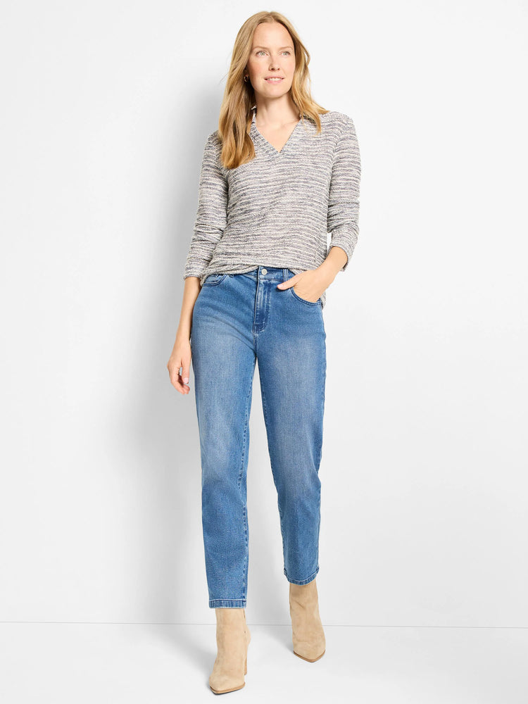 Mélange cream and grey knit polo top with V-neck, collar, and long sleeves.