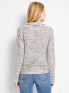 Cream and muted blue rope-textured polo top with horizontal shimmer stripes and a collar. Back view.