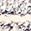 Rough, mottled light grey and off-white, speckled with dark grey, like granite.