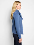 Muted blue knit moto jacket with a draped collar, long sleeves, and subtle side pockets.