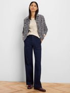 Cropped knit jacket with navy and white plaid pattern, a collar, and front buttons.