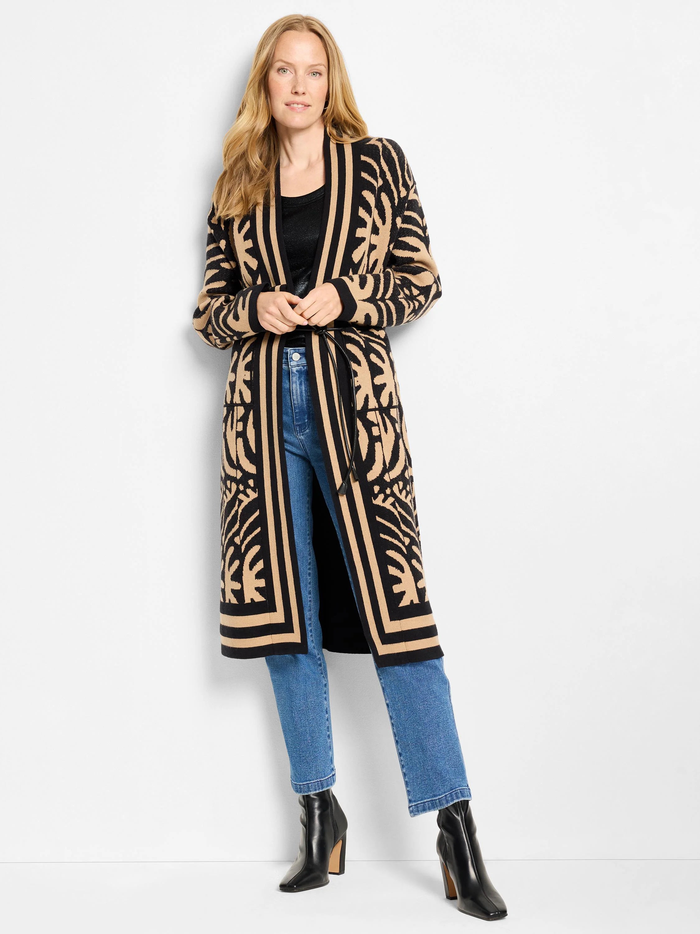 Black ribbed tank top with subtle sheen, partially visible under a long black and tan patterned cardigan.