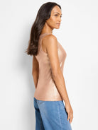 Form-fitting, shimmering rose gold ribbed tank top with a high neckline.