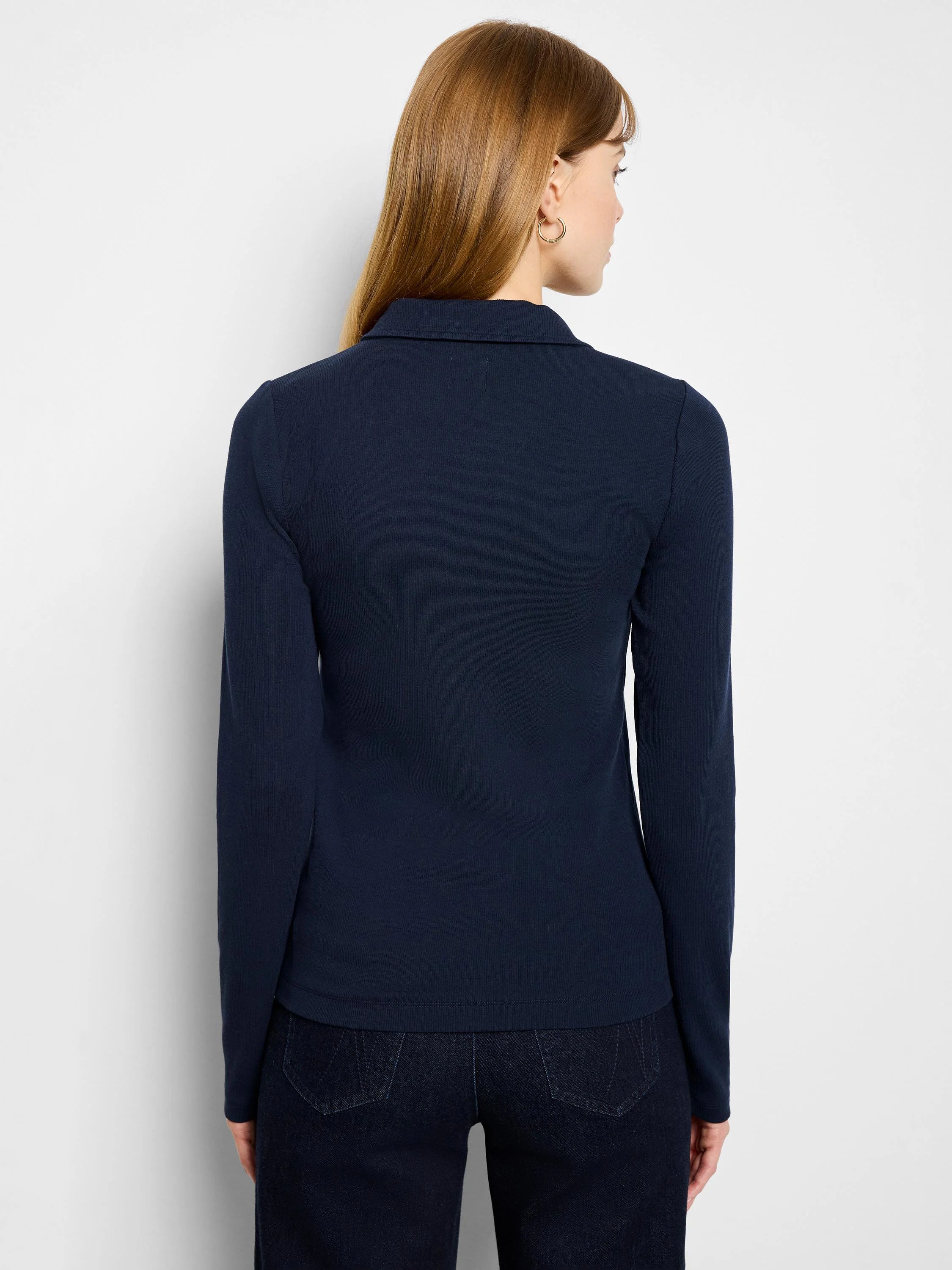 Dark blue long-sleeve knit polo with ribbed texture, shown from the back on a model.