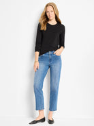 Black long-sleeve crew neck knit top.