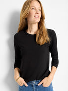 Black, fitted crew neck long sleeve top.