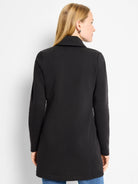 Black About Town Jacket with a high collar, long sleeves, and tunic length, shown on a model from the back.