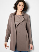 Taupe long-line jersey jacket with wide collar, front snap closures, and vertical slit pockets on front.