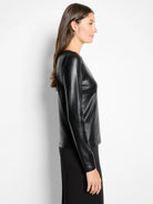 A black glazed, ribbed long-sleeve boat neck tee, worn by a model.