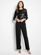 Black, long-sleeved shirt; boat neck; subtle sheen.
