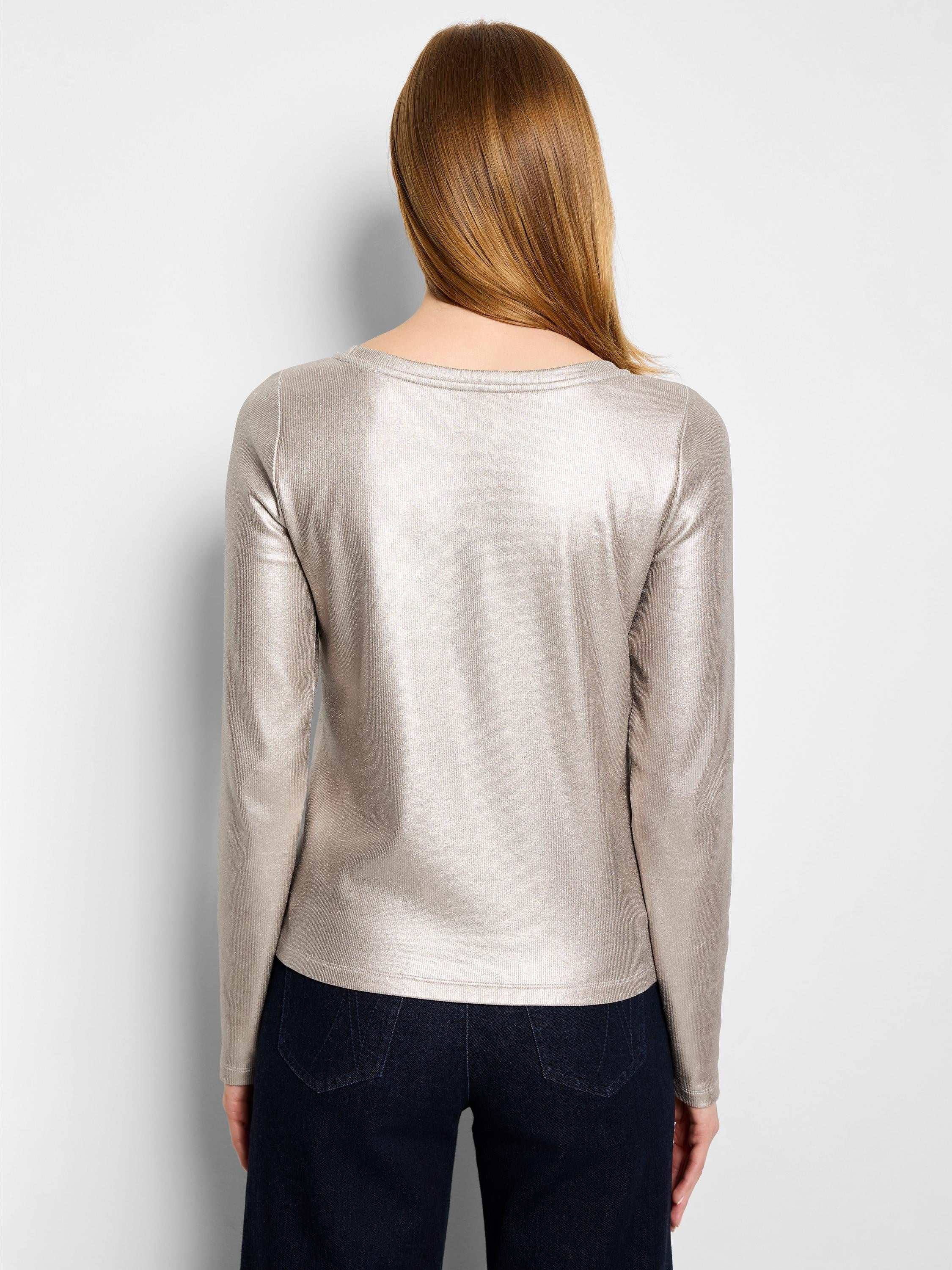 Back view of a shimmering beige ribbed long-sleeve boat neck tee worn by a model.