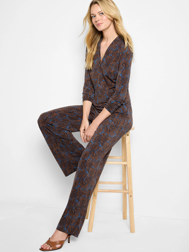 Brown & blue feather fern print V-neck wrap top with 3/4 sleeves, worn with matching pants.