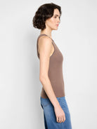 Fitted brown ribbed knit tank top with stitched trim on armholes and neckline, worn by a model.