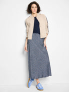 Dark navy ribbed knit tank with a round neckline, partially visible under a beige cardigan.