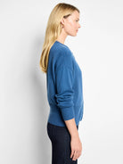 Deep blue pure cotton cardigan with long sleeves, ribbed cuffs and hem. Shown in profile.